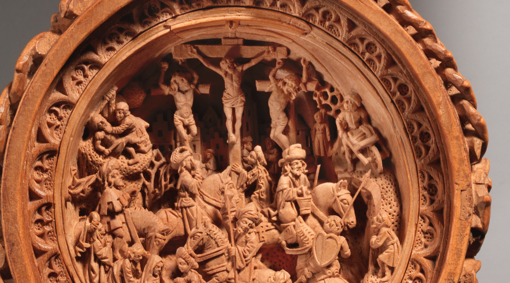 The Crucifixion is carved into the lower half of the interior of the bead.